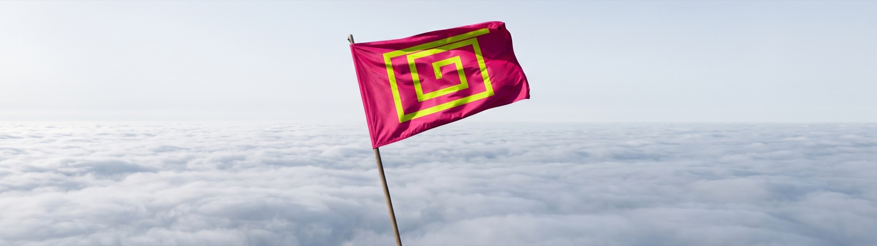 The flag of the Republic of Saint Guillermo flying above a sea of cloud